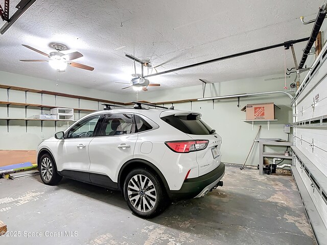 3090 Rio Pino S, Indialantic, FL 32903 - garage with a garage door opener and a ceiling fan
