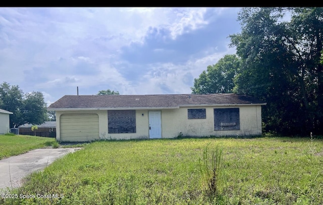 849 Upland Ave SE, Palm Bay, FL 32909 - ranch-style home with driveway, an attached garage, stucco siding, and a front lawn