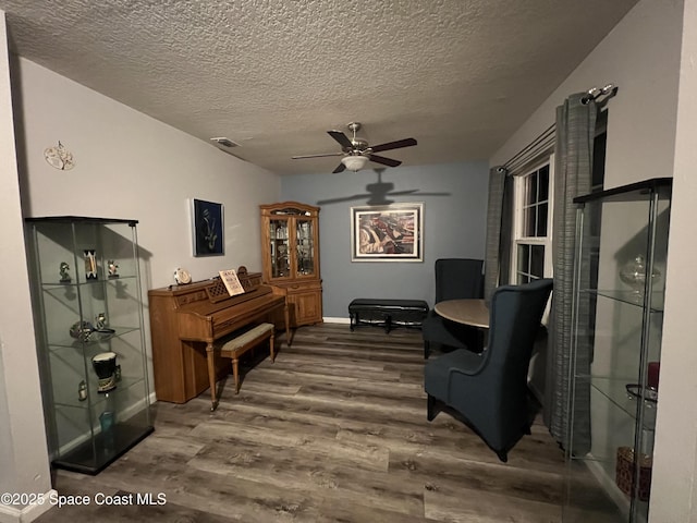 1015 Swiss Pointe Ln, Rockledge, FL 32955 - living area with wood finished floors, a ceiling fan, and a textured ceiling