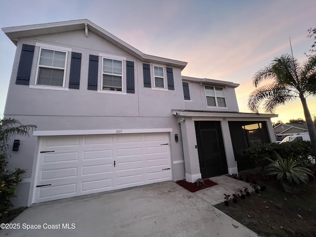 1015 Swiss Pointe Ln, Rockledge, FL 32955 - view of front of property featuring an attached garage, stucco siding, driveway, and a sunroom