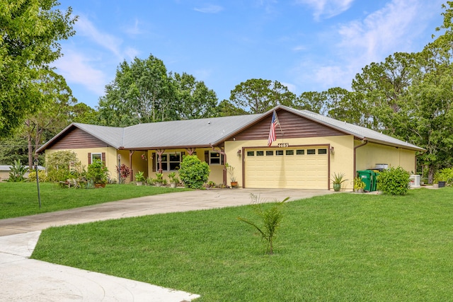 4685 Lee St, Cocoa, FL 32926 - ranch-style home with concrete driveway, an attached garage, a front lawn, and stucco siding
