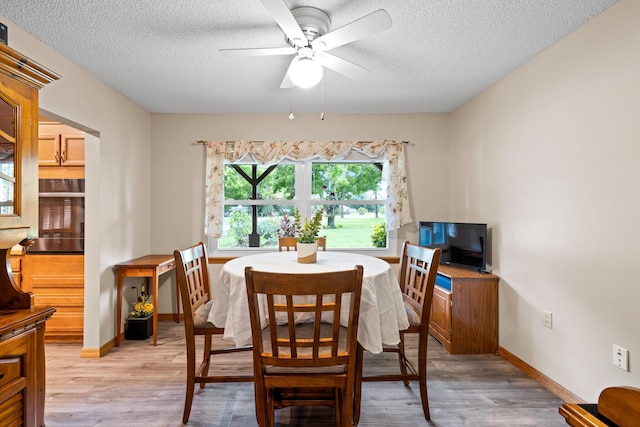 4685 Lee St, Cocoa, FL 32926 - dining space featuring a textured ceiling, light wood-type flooring, and ceiling fan