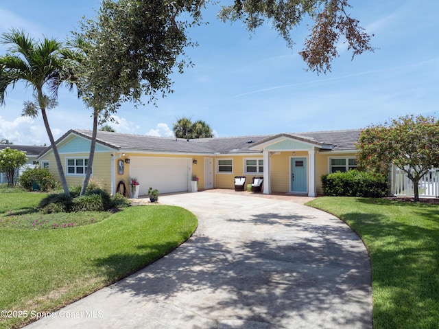 211 Jamaica Dr, Cocoa Beach, FL 32931 - single story home with an attached garage, a front lawn, and driveway