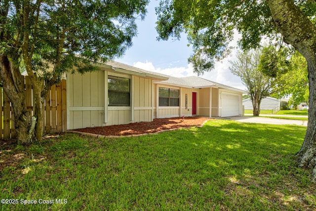 2169 Wagonwheel Ave SE, Palm Bay, FL 32909 - ranch-style home with an attached garage, concrete driveway, and a front yard