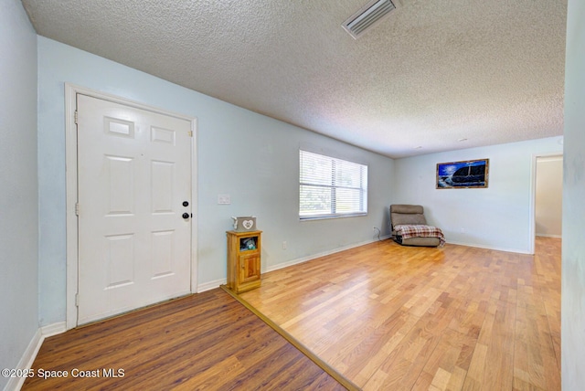 2169 Wagonwheel Ave SE, Palm Bay, FL 32909 - entryway featuring wood finished floors and a textured ceiling