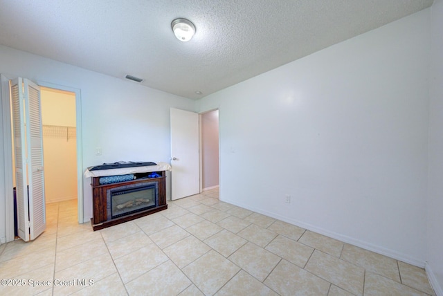 2169 Wagonwheel Ave SE, Palm Bay, FL 32909 - unfurnished room with a textured ceiling and light tile patterned flooring