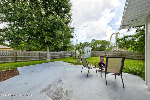 2169 Wagonwheel Ave SE, Palm Bay, FL 32909 - fenced backyard featuring a patio and a storage unit