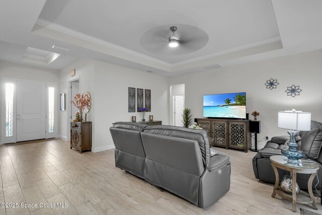 1401 Wilder Rd SE, Palm Bay, FL 32909 - living area featuring a raised ceiling, ceiling fan, crown molding, and light wood-style floors