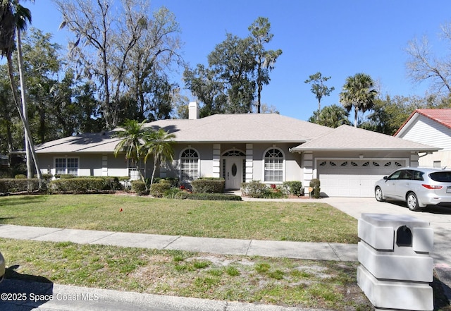 474 Winding Creek Pl, Longwood, FL 32779 - single story home with an attached garage, a chimney, a front yard, and driveway