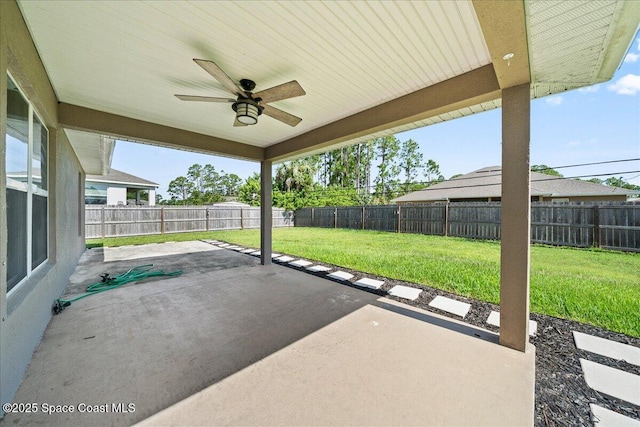 215 Olin Rd SW, Palm Bay, FL 32908 - fenced backyard featuring a ceiling fan and a patio area