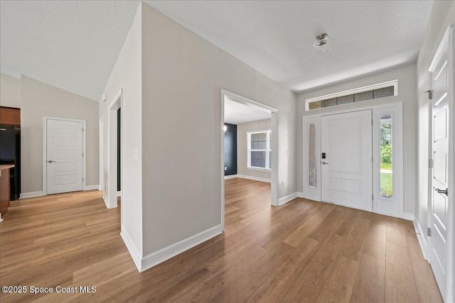 215 Olin Rd SW, Palm Bay, FL 32908 - entryway featuring light wood finished floors and vaulted ceiling