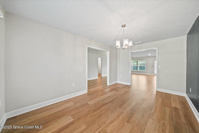 215 Olin Rd SW, Palm Bay, FL 32908 - spare room with a chandelier and light wood-style floors