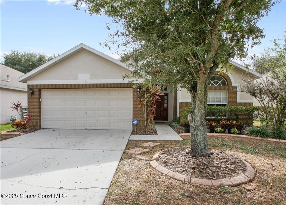 7603 Wiltshire Park Pl, Apollo Beach, FL 33572 - view of front of home with brick siding, stucco siding, driveway, and a garage