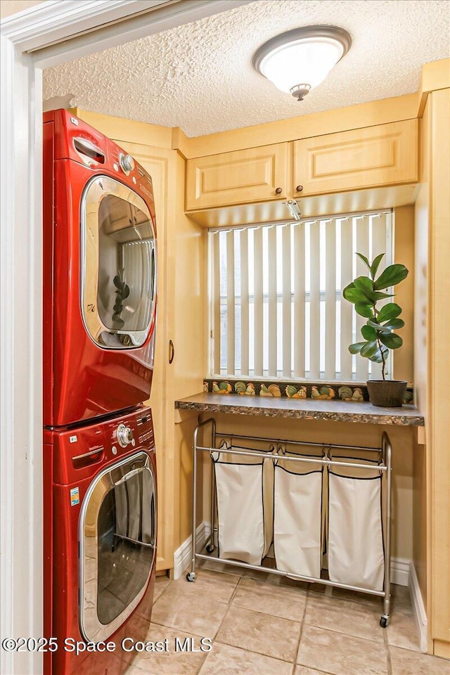 970 Pelican Ln, Rockledge, FL 32955 - laundry area with stacked washer / dryer, light tile patterned floors, and a textured ceiling
