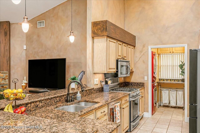 970 Pelican Ln, Rockledge, FL 32955 - kitchen featuring appliances with stainless steel finishes, light tile patterned floors, stone counters, decorative light fixtures, and light brown cabinets