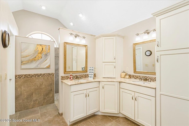 970 Pelican Ln, Rockledge, FL 32955 - full bathroom with a walk in shower, double vanity, vaulted ceiling, tile patterned flooring, and recessed lighting