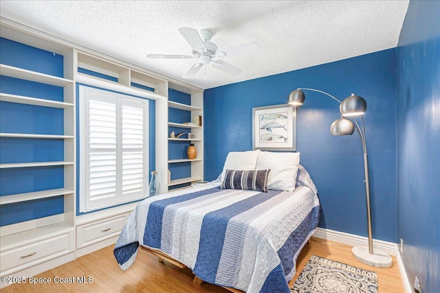 970 Pelican Ln, Rockledge, FL 32955 - bedroom featuring wood finished floors, a textured ceiling, and a ceiling fan