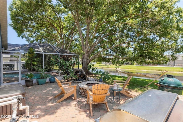 970 Pelican Ln, Rockledge, FL 32955 - view of patio with a fire pit, glass enclosure, and a water view