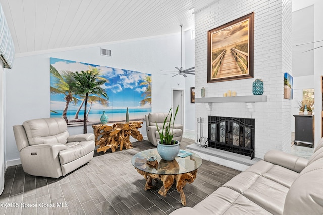 2945 Newfound Harbor Dr, Merritt Island, FL 32952 - living room featuring high vaulted ceiling, ceiling fan, a brick fireplace, wood finished floors, and crown molding