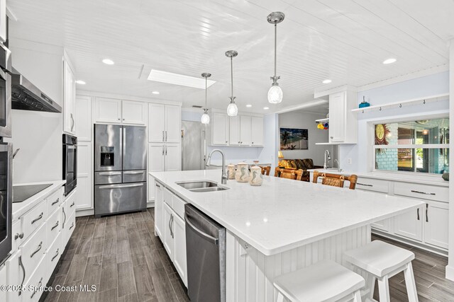 2945 Newfound Harbor Dr, Merritt Island, FL 32952 - kitchen with appliances with stainless steel finishes, white cabinetry, dark wood-style flooring, and recessed lighting