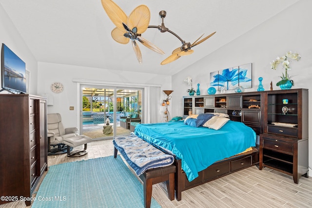 2945 Newfound Harbor Dr, Merritt Island, FL 32952 - bedroom featuring vaulted ceiling, access to exterior, light wood-style floors, and ceiling fan