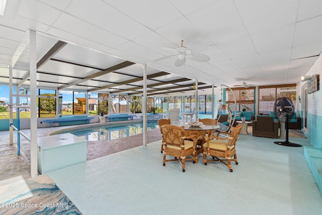 2945 Newfound Harbor Dr, Merritt Island, FL 32952 - sunroom with a ceiling fan, outdoor dining space, a hot tub, beam ceiling, and a swimming pool