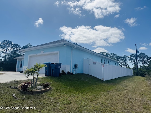 1305 Rabbit Street Se Port Malabar Unit 22, Palm Bay, FL 32909 - view of home's exterior featuring a garage, concrete driveway, and stucco siding