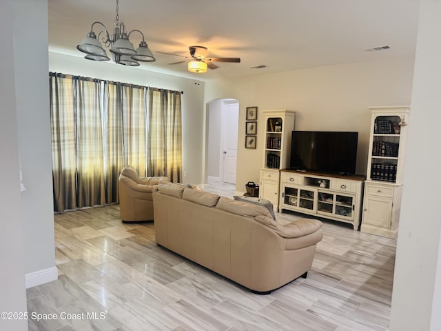1305 Rabbit Street Se Port Malabar Unit 22, Palm Bay, FL 32909 - living room featuring arched walkways, a chandelier, and a ceiling fan