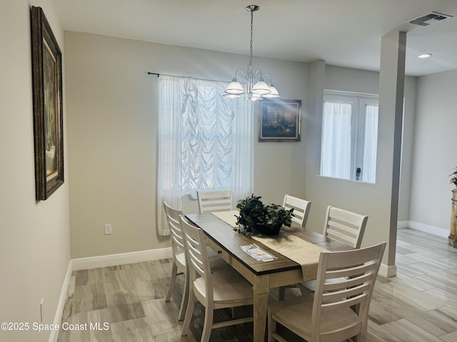 1305 Rabbit Street Se Port Malabar Unit 22, Palm Bay, FL 32909 - dining room featuring baseboards and a chandelier