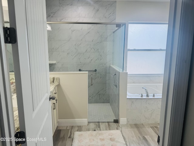 1305 Rabbit Street Se Port Malabar Unit 22, Palm Bay, FL 32909 - bathroom with a bath, tiled shower, vanity, and wood finished floors