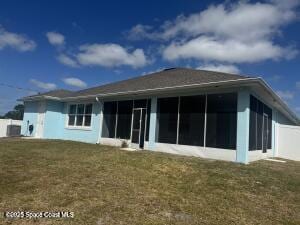 1305 Rabbit Street Se Port Malabar Unit 22, Palm Bay, FL 32909 - back of property featuring a sunroom and a lawn