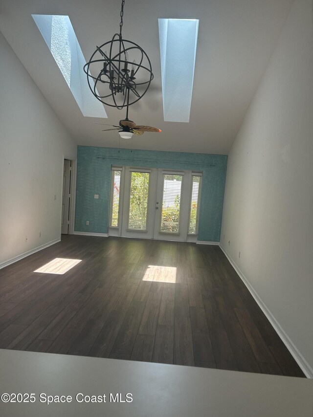 537 6th St, Vero Beach, FL 32962 - unfurnished living room featuring a skylight, ceiling fan, high vaulted ceiling, and wood finished floors
