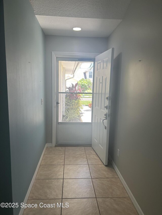 537 6th St, Vero Beach, FL 32962 - doorway featuring a textured ceiling and light tile patterned floors