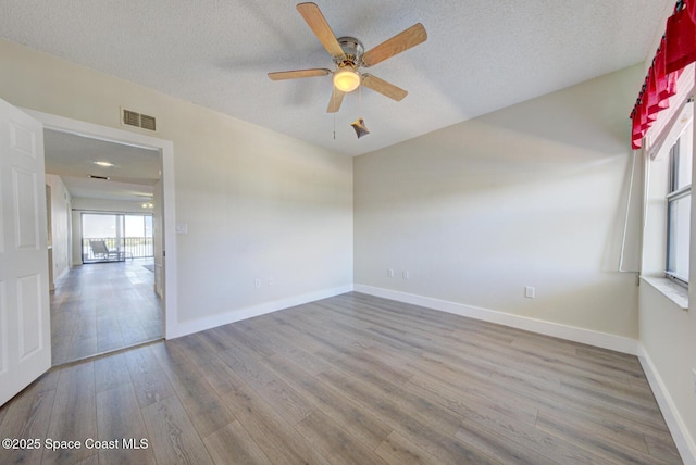 3609 S Banana River Blvd Unit C511, Cocoa Beach, FL 32931 - empty room featuring wood finished floors, ceiling fan, and a textured ceiling