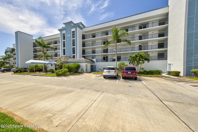 3609 S Banana River Blvd Unit C511, Cocoa Beach, FL 32931 - view of apartment building / complex featuring uncovered parking