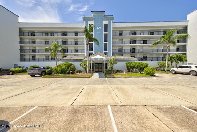 3609 S Banana River Blvd Unit C511, Cocoa Beach, FL 32931 - view of apartment building / complex with uncovered parking