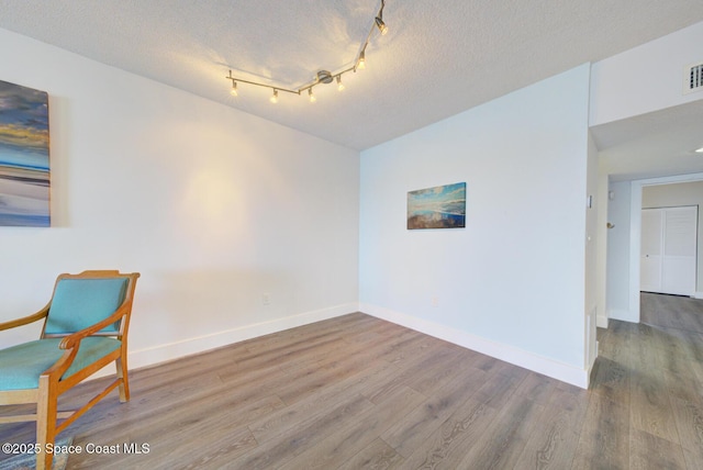 3609 S Banana River Blvd Unit C511, Cocoa Beach, FL 32931 - spare room with wood finished floors and a textured ceiling