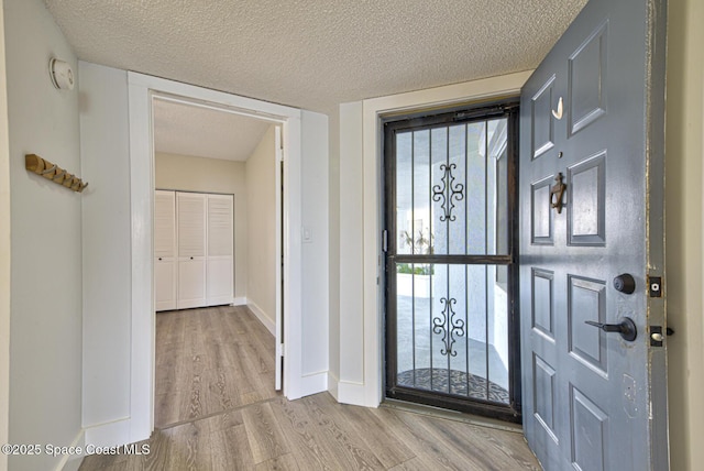 3609 S Banana River Blvd Unit C511, Cocoa Beach, FL 32931 - entrance foyer with wood finished floors and a textured ceiling