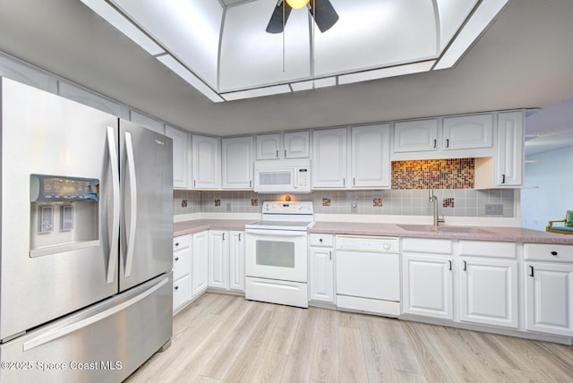 3609 S Banana River Blvd Unit C511, Cocoa Beach, FL 32931 - kitchen featuring white appliances, light countertops, white cabinets, and light wood-style floors
