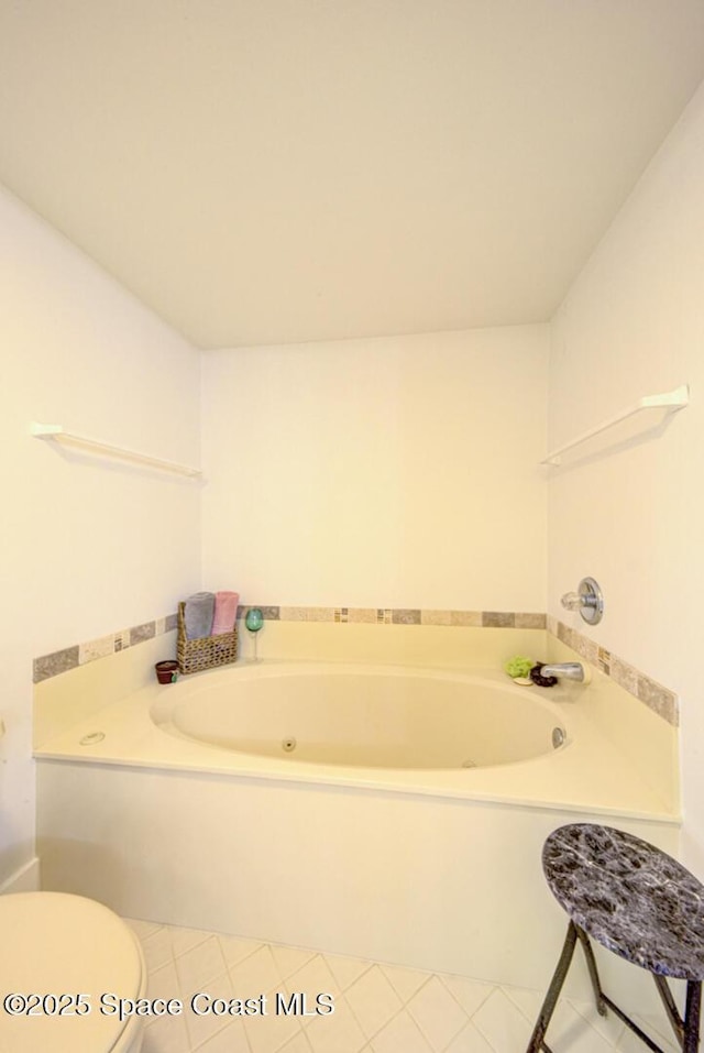 3609 S Banana River Blvd Unit C511, Cocoa Beach, FL 32931 - bathroom with a tub with jets and tile patterned flooring