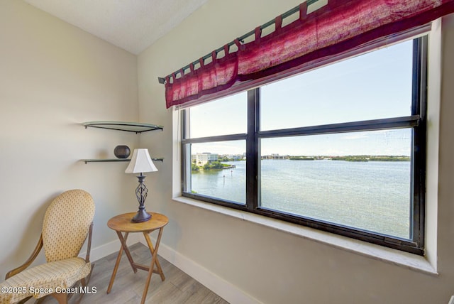3609 S Banana River Blvd Unit C511, Cocoa Beach, FL 32931 - living area with wood finished floors and a water view
