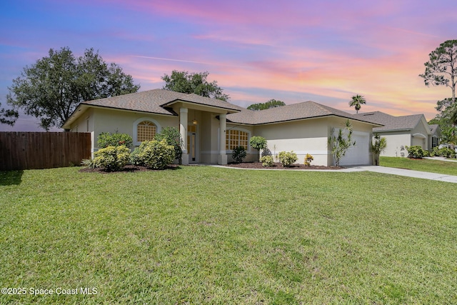 130 Cameron St SE, Palm Bay, FL 32909 - ranch-style home with an attached garage, stucco siding, concrete driveway, and a shingled roof