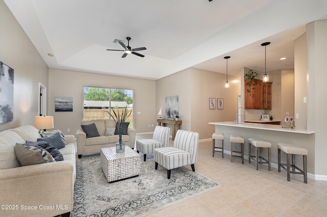 130 Cameron St SE, Palm Bay, FL 32909 - living area featuring ceiling fan, a tray ceiling, light tile patterned flooring, and recessed lighting