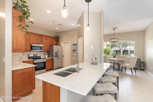 130 Cameron St SE, Palm Bay, FL 32909 - kitchen with appliances with stainless steel finishes, light tile patterned floors, backsplash, a kitchen bar, and recessed lighting