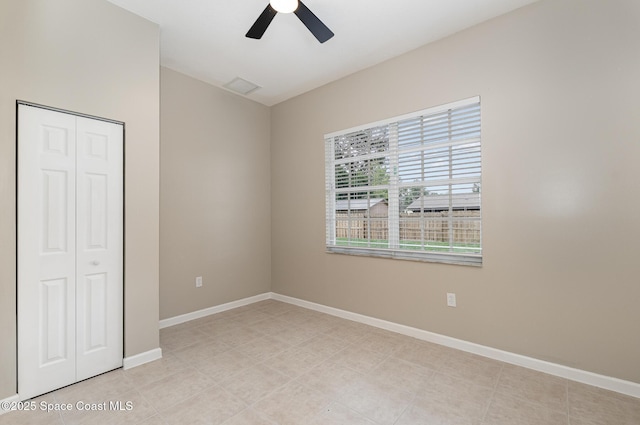130 Cameron St SE, Palm Bay, FL 32909 - unfurnished bedroom with a closet, a ceiling fan, and light tile patterned floors