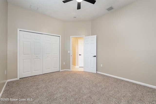 130 Cameron St SE, Palm Bay, FL 32909 - unfurnished bedroom featuring carpet, a closet, and a ceiling fan