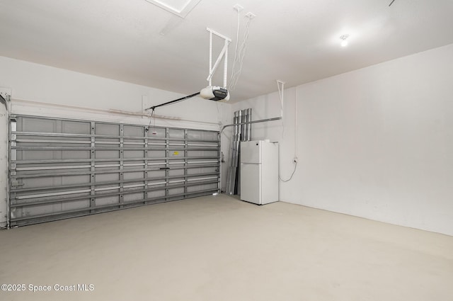 130 Cameron St SE, Palm Bay, FL 32909 - garage with freestanding refrigerator and a garage door opener