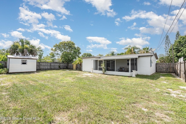 2515 Andrews Ave, Melbourne, FL 32935 - back of house featuring a sunroom, a fenced backyard, and a storage shed