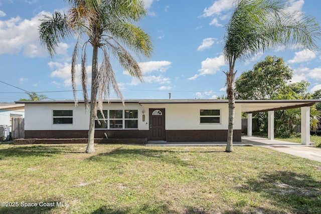 2515 Andrews Ave, Melbourne, FL 32935 - ranch-style home featuring an attached carport, concrete driveway, and a front lawn