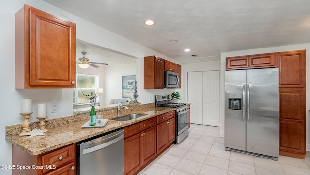 2515 Andrews Ave, Melbourne, FL 32935 - kitchen featuring appliances with stainless steel finishes, light stone counters, light tile patterned floors, ceiling fan, and recessed lighting